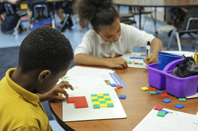 Students using math manipulatives are engaged in multi-sensory learning activities.