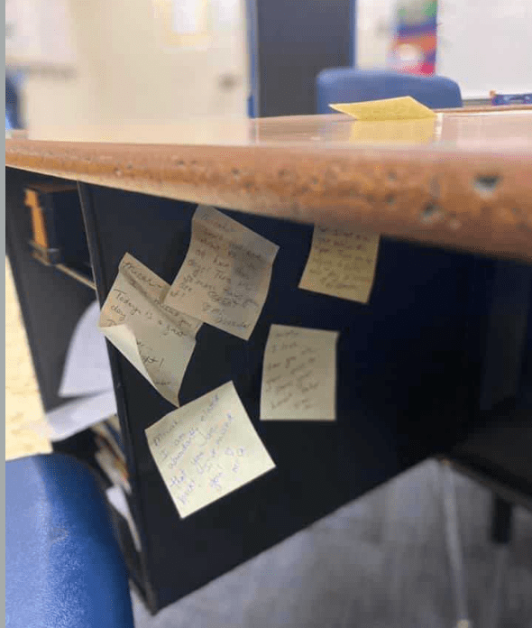 A collection of sticky notes placed under a desk.