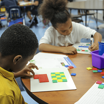 Students using math manipulatives are engaged in multi-sensory learning activities.