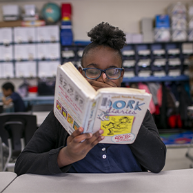 Student reading at desk.