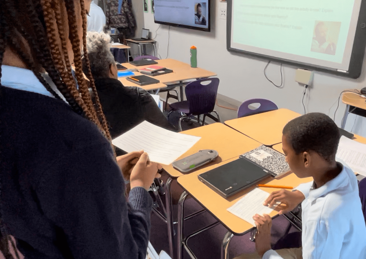 Students look over an assignment during class.