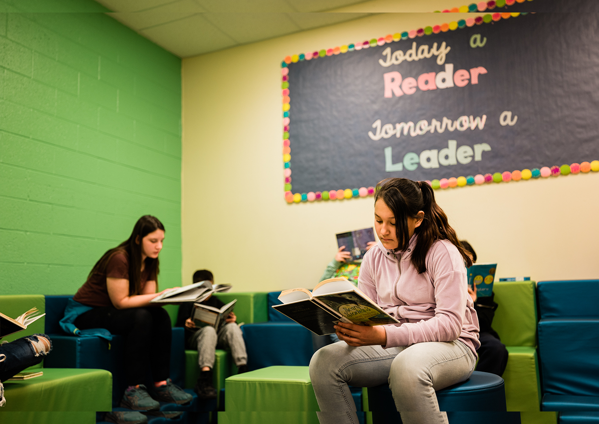 Older students are enjoying their time in a relaxed space, reading independently.