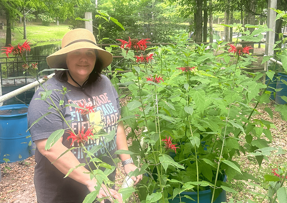 The author, Christy Washington standing outside in a garden.