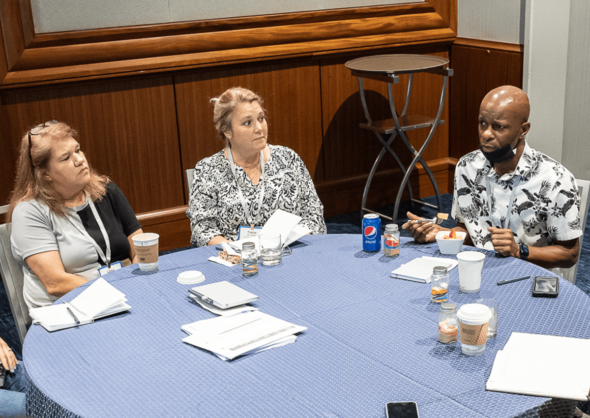 A group of educators are engaged in a deep discussion.